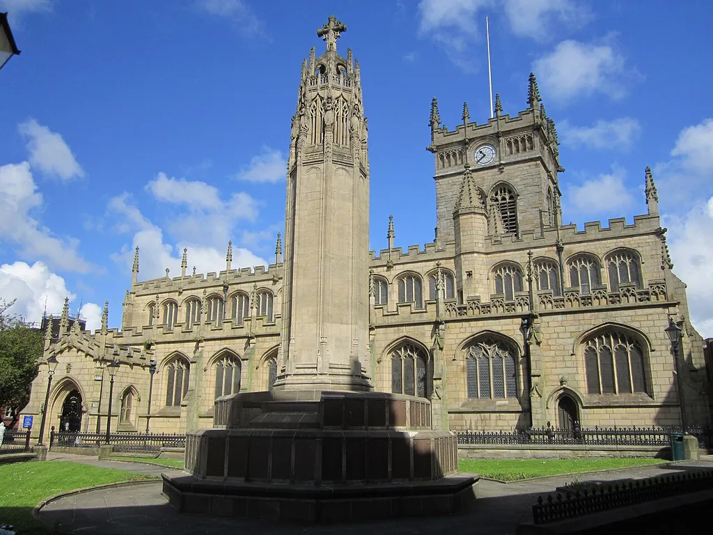 All Saints' parish church, Wigan, Greater Manchester, seen from the south with the war memorial in the foreground