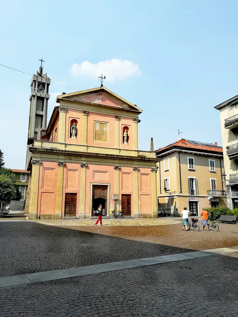 Small square XI febbraio and ancient church of S.S. Marco and Gregorio, Cologno Monzese, Italy.