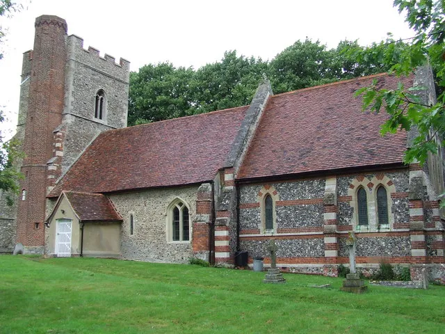 St Augustine Of Canterbury parish church, Ashen, Essex, seen from the southeast. The brick stair-turret on the west tower (left) was added in the 16th century. The Gothic Revival chancel (right) was built in 1857.