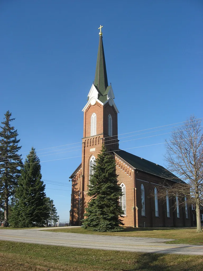 Front and northern side of St. Patrick's Church in Glynwood, an unincorporated community in Moulton Township, Auglaize County, Ohio, United States. Built in 1883, the church was listed on the National Register of Historic Places as a part of the Cross-Tipped Churches of Ohio Thematic Resources.