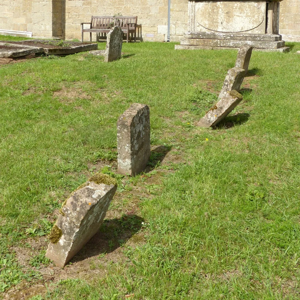 Photograph of a group of gravestones in the churchyard of St Peter and St Paul's Church, Upton Nottinghamshire, England