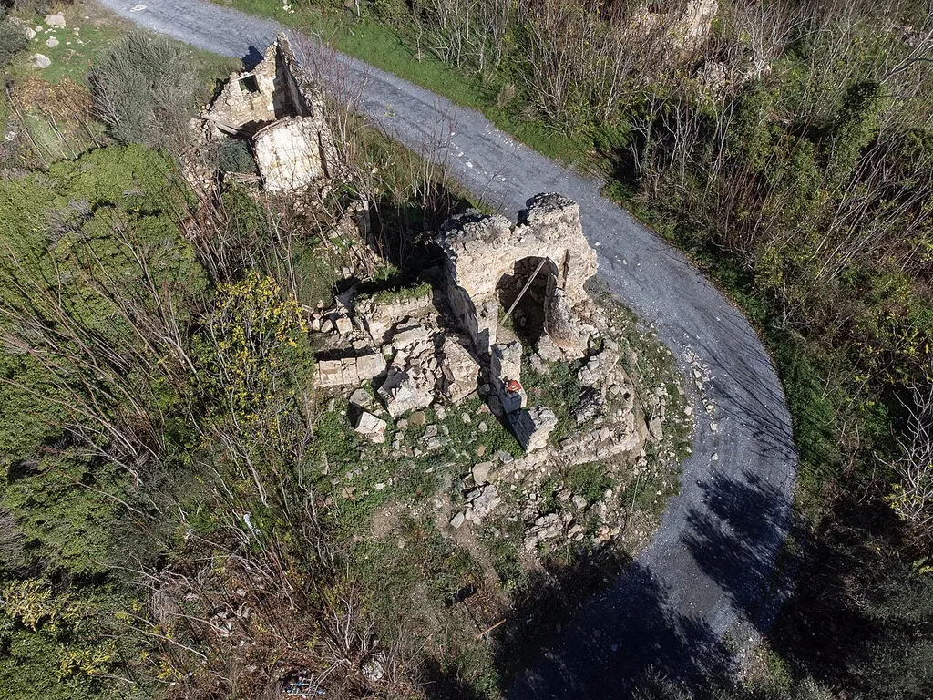The ruins of the church of Saint George in Kato Astrakoi, Crete. The 2021 Arkalochori earthquake caused the one of its two surviving arches to collapse.