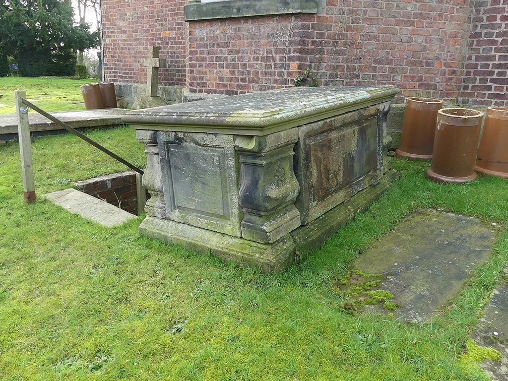Table tomb by east wall of St Luke's Church: Grade II listed building in Goostrey, Cheshire. .mw-parser-output .messagebox{margin:4px 0;width:auto;border-collapse:collapse;border:2px solid var(--border-color-progressive,#6485d1);background-color:var(--background-color-neutral-subtle,#fbfcff);color:var(--color-base,#202122);box-sizing:border-box;border-inline-start-width:8px}.mw-parser-output .messagebox.mbox-small{font-size:88%;line-height:1.25em}.mw-parser-output .mbox-warning,.mw-parser-output .mbox-speedy{border:2px solid var(--border-color-error,#b22222);background:var(--background-color-error-subtle,#ffdbdb);border-inline-start-width:8px}.mw-parser-output .mbox-serious,.mw-parser-output .mbox-delete,.mw-parser-output .mbox-stop{border:2px solid var(--border-color-error,#b22222);border-inline-start-width:8px}.mw-parser-output .mbox-issue,.mw-parser-output .mbox-content{border:2px solid #f28500;background:var(--background-color-warning-subtle,#ffe);border-inline-start-width:8px}.mw-parser-output .mbox-query,.mw-parser-output .mbox-style{border:2px solid #f4c430;background:var(--background-color-warning-subtle,#ffe);border-inline-start-width:8px}.mw-parser-output .mbox-shit{border:2px solid #960;border-inline-start-width:8px}.mw-parser-output .mbox-license{border:2px solid #88a;border-inline-start-width:initial}.mw-parser-output .mbox-legal{border:2px solid var(--border-color-notice,#666);background:var(--background-color-base,#fff);border-inline-start-width:8px}.mw-parser-output .mbox-honor{border:2px solid #ca3;background:var(--background-color-warning-subtle,#fcf4db);border-inline-start-width:8px}.mw-parser-output .mbox-growth{border:2px solid #8d4;background:var(--background-color-success-subtle,#d5fdf4);border-inline-start-width:8px}.mw-parser-output .mbox-move{border:2px solid #93c;border-inline-start-width:8px}.mw-parser-output .mbox-protection,.mw-parser-output .mbox-message{border:2px solid var(--border-color-base,#aaa);border-inline-start-width:8px}.mw-p