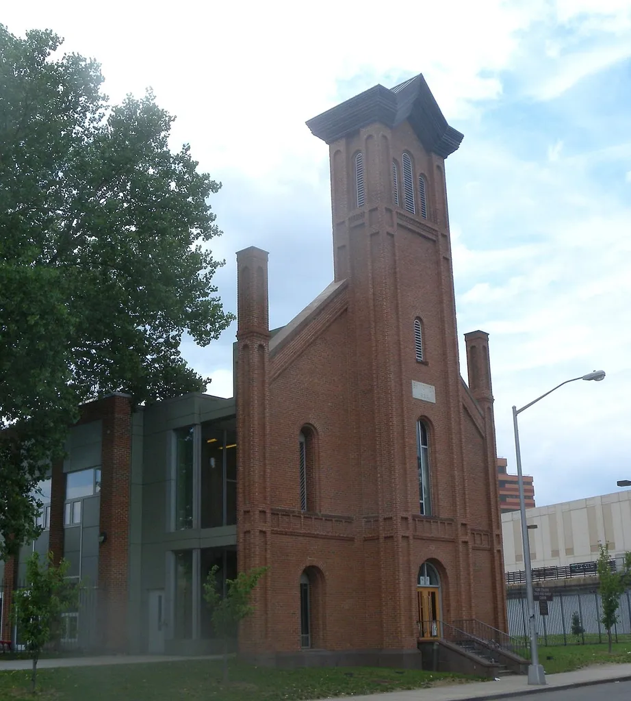 Looking northwest across 160th Street at Saint Monica's, now a college day care, on a partly cloudy midday.