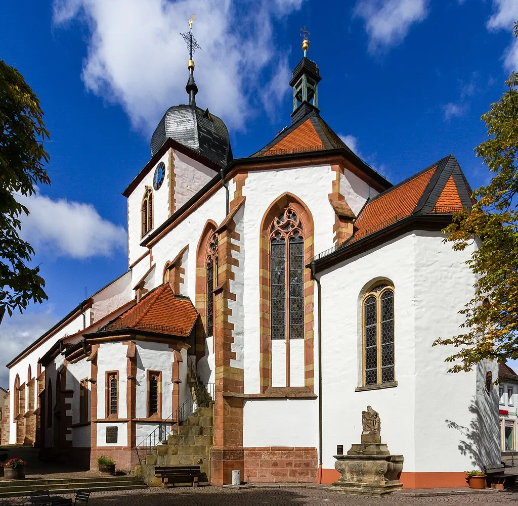 This is a photograph of a cultural monument.It is on the list of cultural monuments of Wachenheim an der Weinstraße. Designation: Shared church St. Georg Construction time: 12th century Description: Picturesque staggered building group Tower possibly still from the 12th century, bell storey 1686–88, increasing designated 1712. Late gothic choir, second quarter of the 15th century, post-gothic little choir 1720/21. Side chapel 1441, sacristy second half of the 15th century. Neo-gothic nave, 1860/61, architects K. Kaercher, Neustadt, extension by Franz Schöberl, Speyer. In front of the choir: late baroque sandstone cross, designated 1753. Procession-altar, monumental yellow sandstone altar, allegedly 1707 by Johann Georg Eisinger. Pietà, second half of the 16th century. Townscape formative with the Bruder-Ludwig-Kapelle (Weinstraße 27). Place: Wachenheim an der Weinstraße, Collective municipality Wachenheim, District Bad Dürkheim, Rhineland-Palatinate, Germany Location: Weinstraße House number: 28
