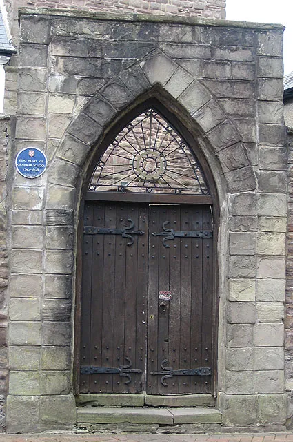 Entrance to former church and grammar school St. John's Church is thought to date from the early 1300s but once St. Marys Priory was given to the people for use as their parish church following the dissolution of the monasteries, St. Johns became disused and in 1542 it became the towns grammar school. Henry VIII gave tithes, once used to support the priory, to the school. In 1898 a new school was built away from the town centre and named King Henry VIII Grammar School. St.Johns was then purchased by the Freemasons and used as their lodge.