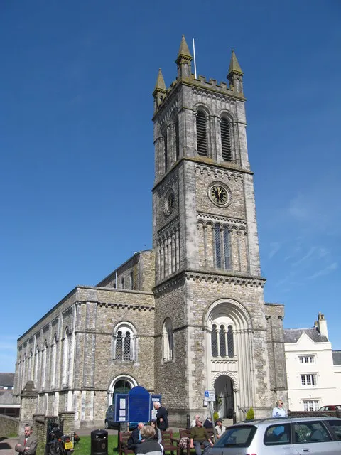 St. Pauls Church, Honiton, Devon St. Paul's Church was built in 1835 and was consecrated by Bishop Henry Philpotts, Bishop of Exeter, in 1838. It is built of local chert and Beer stone and was designed by Charles Fowler of London in the Norman style. Owing to the orientation of the site on which it stands, the Church actually lies North-South. It is 132 feet in length and 58 feet in breadth. The tower, which is a conspicuous landmark in the Otter valley, is 104 feet high and accommodates a clock made by Matthew Murch of Honiton in 1851. http://www.honitoncofe.org/history.htm