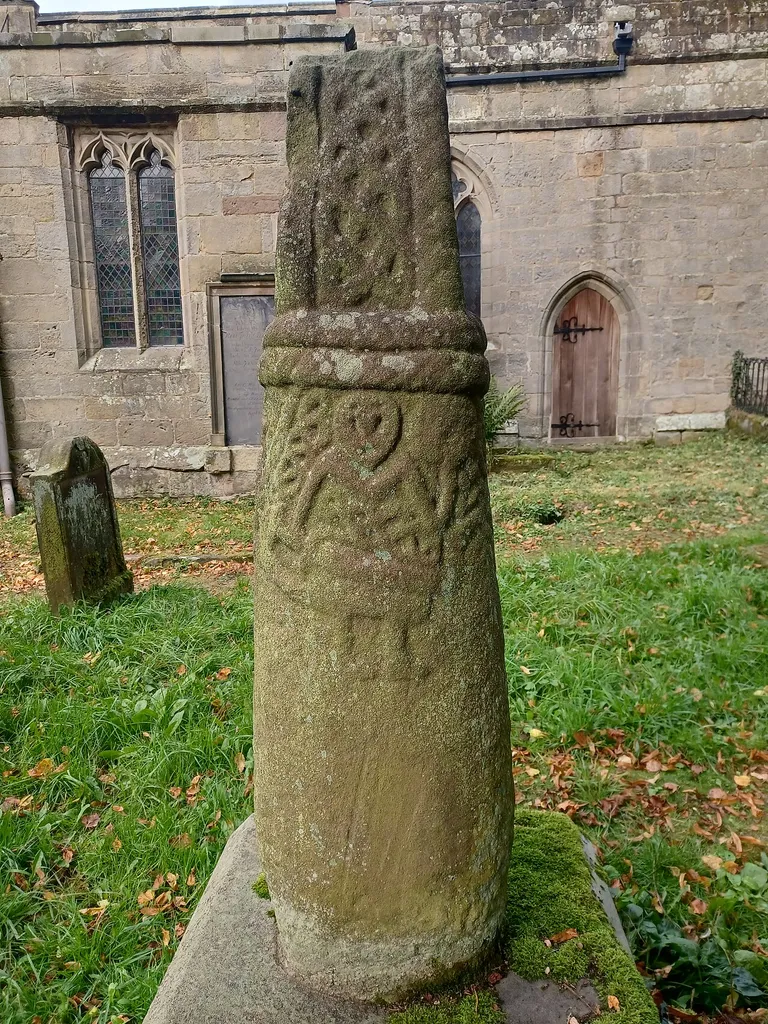 Anglo-Scandinavian cross shaft depicting a Viking warrior, Brailsford churchyard. Possibly a memorial to the person depicted. Early 11th century, scheduled monument. Churchyard of All Saints' Church, Brailsford, Derbyshire, England.