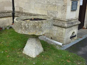 Former font at south west corner of porch of Parish Church of St Nicholas