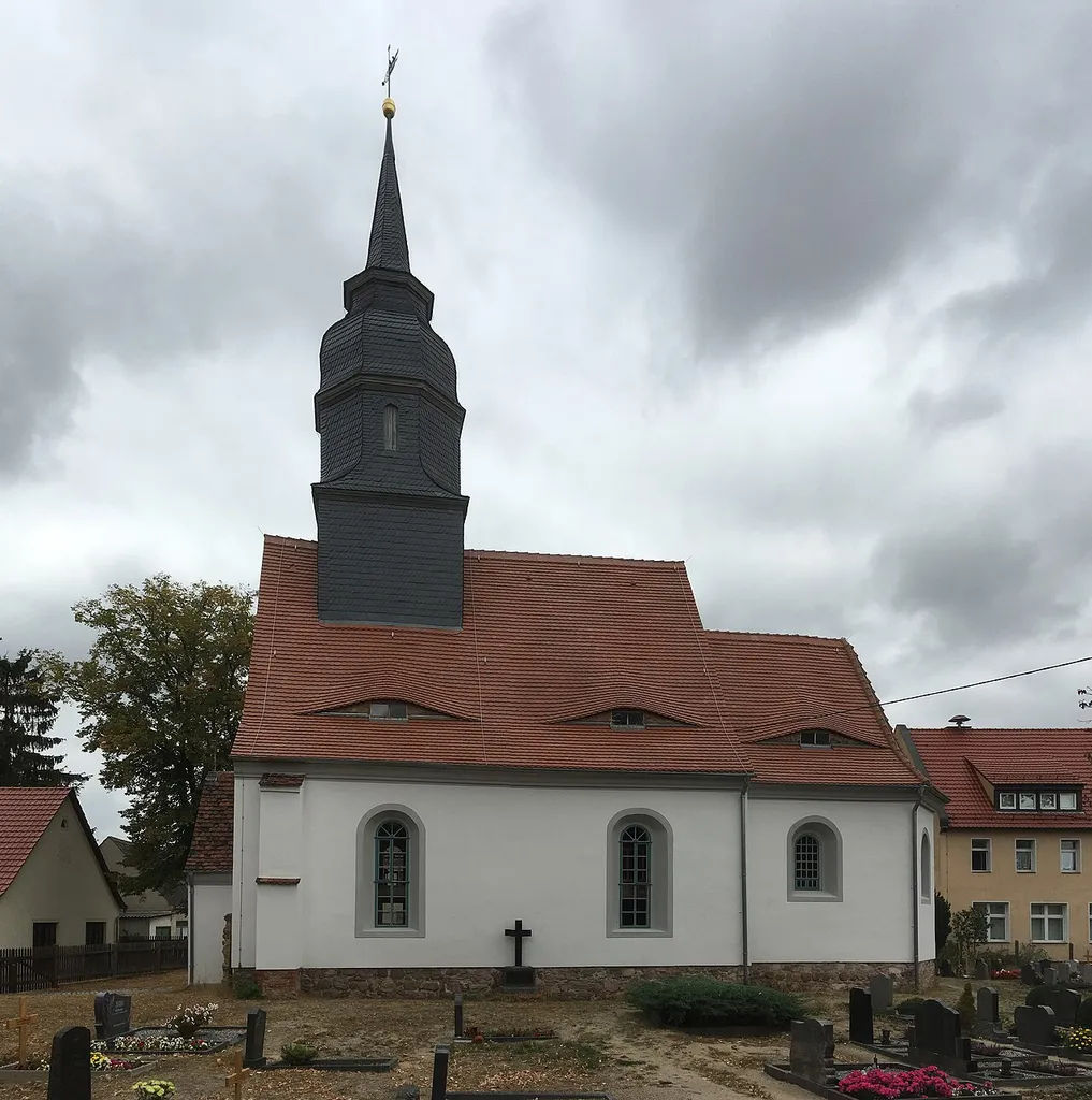 Church with equipments and churchyard with historic tombs in Neiden, Pfarrgasse; Rectangular nave with inserted three-sided choir, northern sacristy and box, full arched windows with skylights rungs, profiled eaves cornice, saddle roof, small entrance hall with stepped arched portal and original door with skylight, ridge turret (square and octagonal with slated, curled hood, ball and vanes), the entire interior (including the bell and the Vasa Sacra) is also a National heritage monument; interior: wooden altar with the figure of the Last Supper from 1657, pulpit with painted figures of the Evangelists and prophets from 1657, glazed box with the arms of Johann Samuel Ringenhayn and his wife, inscribed 1686, sacristy with rib vault, chalice-shaped baptismal font inscribed 1677, three-sided galleries, organ by C. Geissler from Eilenburg (Opus 101); tomb stones: a) Sandstone tombstone of a Adam Riedel erected on the east side of the church / 19th century with rusticated pedestal, crucifix relief and crown cap, b) Baroque tombstone of sandstone with volute framing and angels heads erected at the north sakristy, c) right next to it sandstone tombstone of a pastor with bible and cup relief and lateral volutes; building history, art history and local history of importance; all together cultural heritage monument