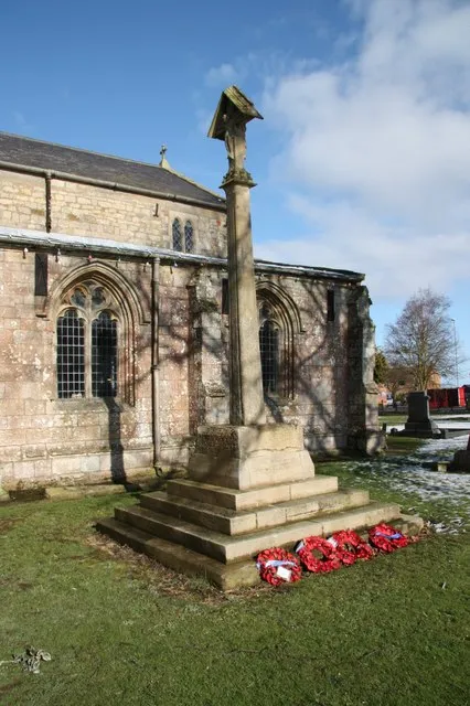 Stone cross in the parish churchyard of SS Peter and Paul, Ingoldmells, Lincolnshire. Originally a Mediæval churchyard cross. Converted in 1600 into a sundial. Restored in 1919 as a war memorial.