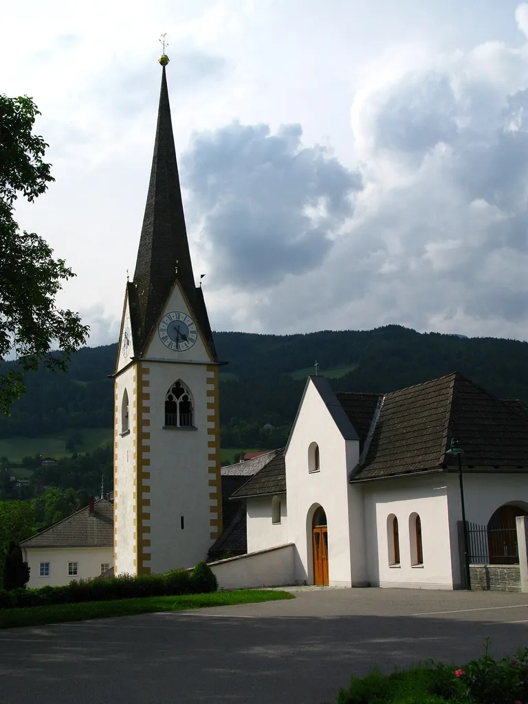 Village Lieseregg near Lake Millstatt (Millstätter See) community of Seeboden / Spittal an der Drau / Carinthia / Austria / EU. On the left side the rectory is located, in the middle of the bell tower and right the old mortuary chapel. In the background the rising Gemeineck mountain called Hirschberg or Hühnersberg.