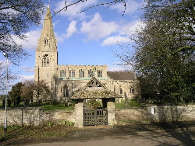 St Peter's parish church, North Rauceby, Lincolnshire, seen from the south. The lych gate has a carved inscription that suggests it was built in memory of a former parishioner.