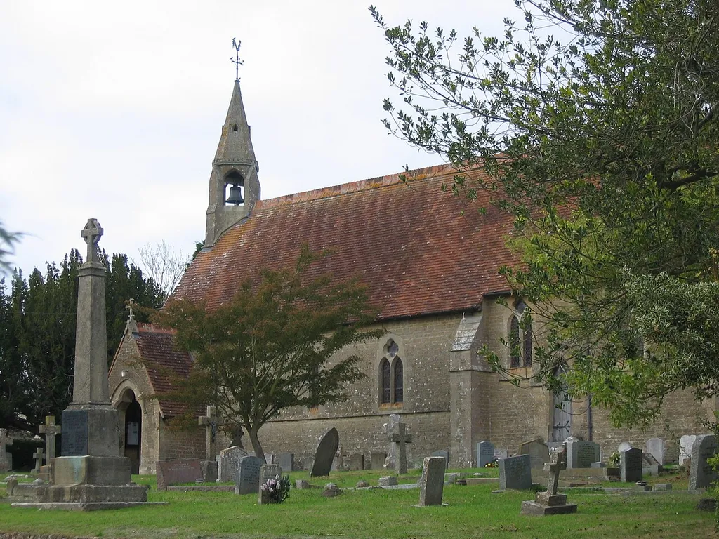 The nave, west bellcote and war memorial of SS Philip and James parish church, Chapmanslade, Wiltshire, seen from the southeast