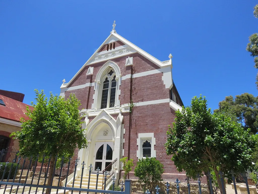 The state heritage listed former Congregational Church, Claremont, Western Australia. The building is listed together with the Congregational Hall, which is located to the left (east) of the church. The front of the hall is also the location of the half-way point between the mail between Perth and Fremantle. The Pillar Box located there is also state heritage listed.