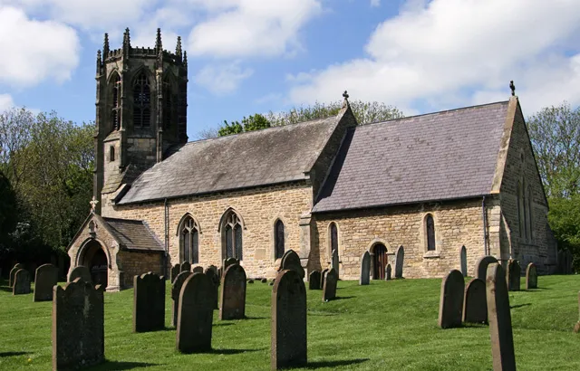 All Saints Church, Sancton, East Riding of Yorkshire, England.The photograph looks towards the south side of the church which has an octagonal tower.