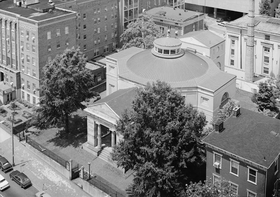 Palladian architecture in VirginiaMonumental Church (1812-14) was designed by architect Robert Mills to commemorate the deaths of seventy-two persons, including Virginia Governor George William Smith, who perished in an 1811 fire that destroyed a theater on the site. Conceived as both an active church and commemorative monument, its dual role is expressed by a stone memorial portico and adjoining octagonal church. As an early example of Greek Revival styling, Monumental Church is derived from the work and ideas of numerous renowned designers, especially Benjamin H. Latrobe. Mills, however, an American-trained architect who explored progressive concepts such as fireproof-construction techniques, is credited with synthesizing contemporary architectural trends into buildings that have become identified with the Federal era. Although Monumental Church was altered and enlarged during the late nineteenth century, subsequent rehabilitations have restored its original appearance.