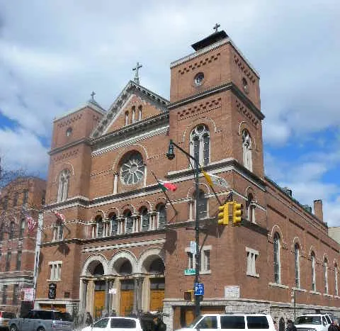 Looking north across 187th St in Little Italy, at Church of Our Lady of Mount Carmel on a mostly sunny morning.
