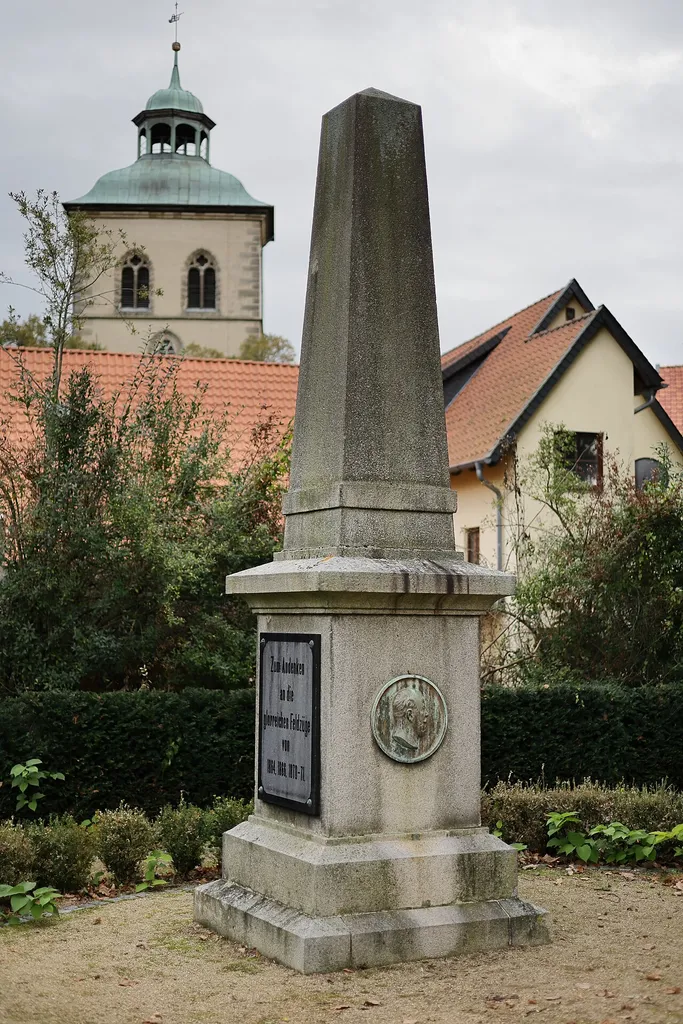 The obelisk commemorating the Wars of Unification in Hornburg, Germany, erected in 1895. On its front side it bears a bronze medallion of Emperor William I. On the left side there is a plaque indicating which wars are being commemorated here. On the right-hand side is a plaque commemorating Hornburg's only casualty, the Jewish merchant's son Joseph Schwabe.